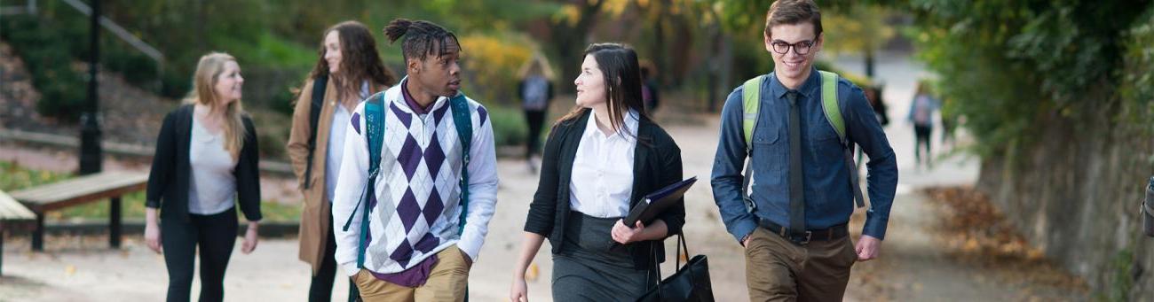 Three students talk while walk up Mortan Hill.